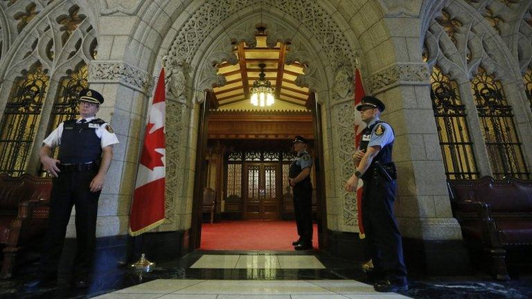 Guards stand outside the Senate chamber on Parliament Hill in Ottawa 9 Harb