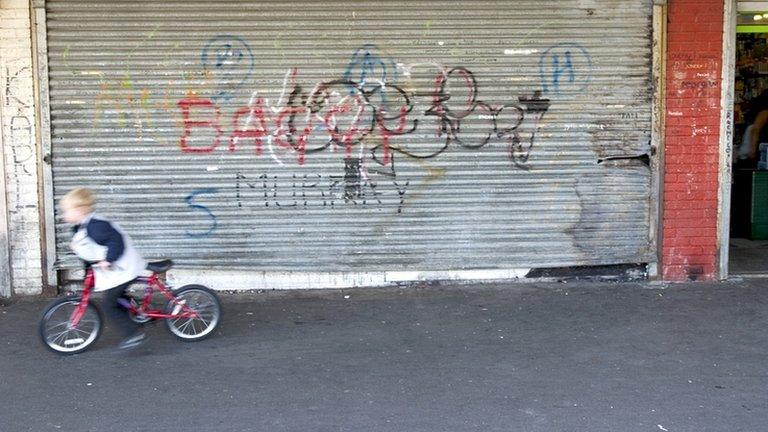 Child outside a closed shop