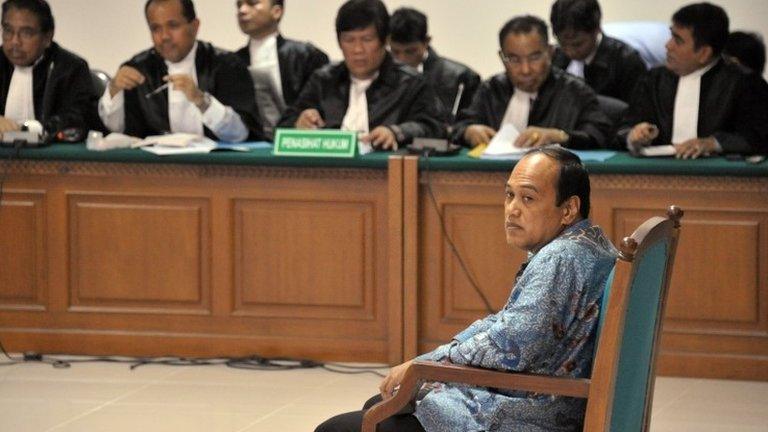 Former chief of the Indonesian police traffic division Djoko Susilo (R) backed by a panel of defence lawyers, listens during the indictment proceeding by the anti-graft court in Jakarta on 23 April 2013 to face trial for corruption charges