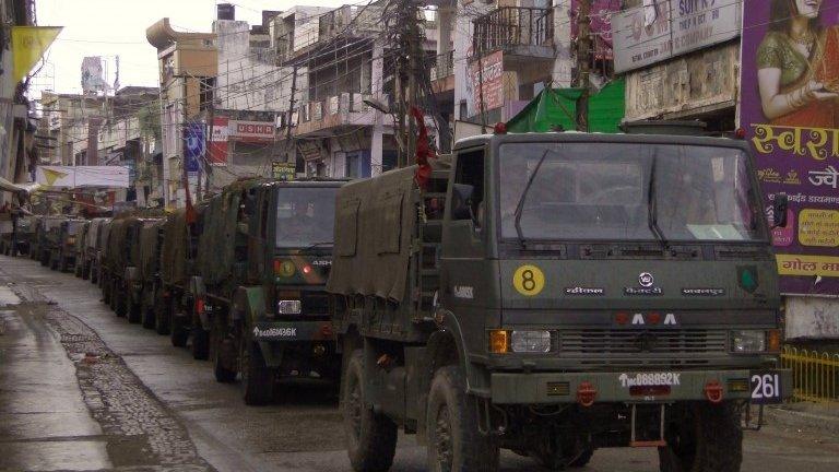 Indian army vehicles patrol on a deserted road during a curfew in Muzaffarnagar, in the northern Indian state of Uttar Pradesh September 8, 2013