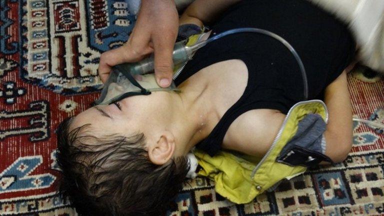 A boy, affected by what activists say is nerve gas, breathes through an oxygen mask in the Damascus suburb of Saqba