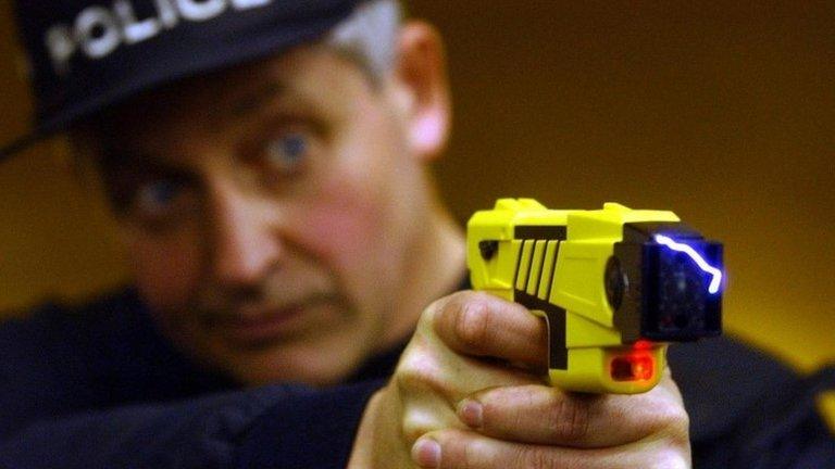 Police officer holding a Taser