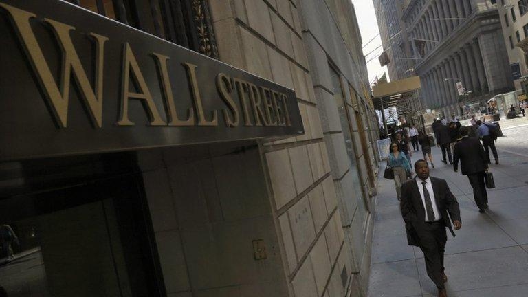 Morning commuters walk on Wall Street in New York's financial district 5 September 2013