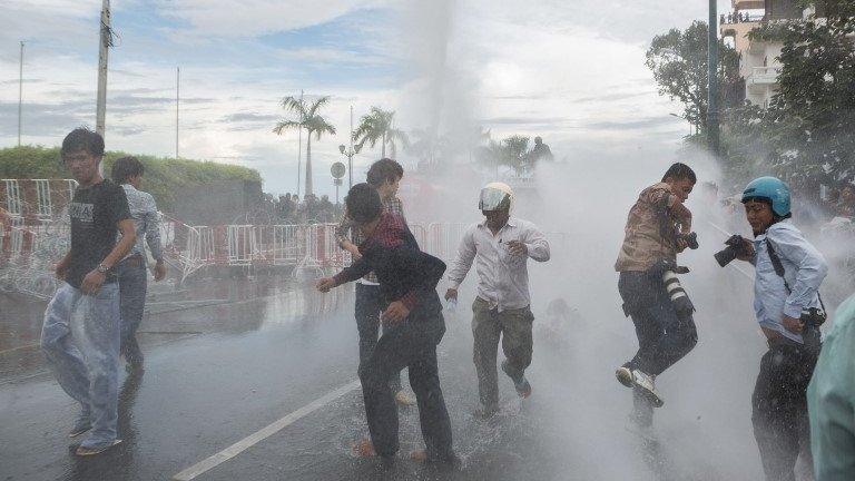 Anti-riot police fire water canons as clashes erupt near the riverside on September 15, 2013 in Phnom Penh, Cambodia.