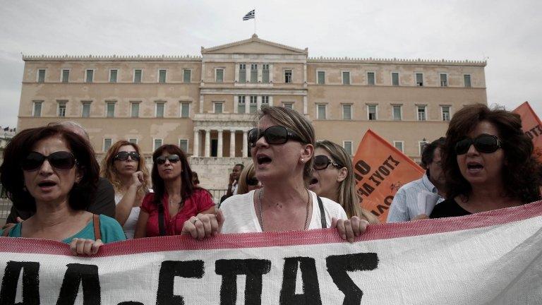 Protesters shout slogans during a rally by high school teachers against layoffs in their sector in front of the parliament in Athens (16 September)