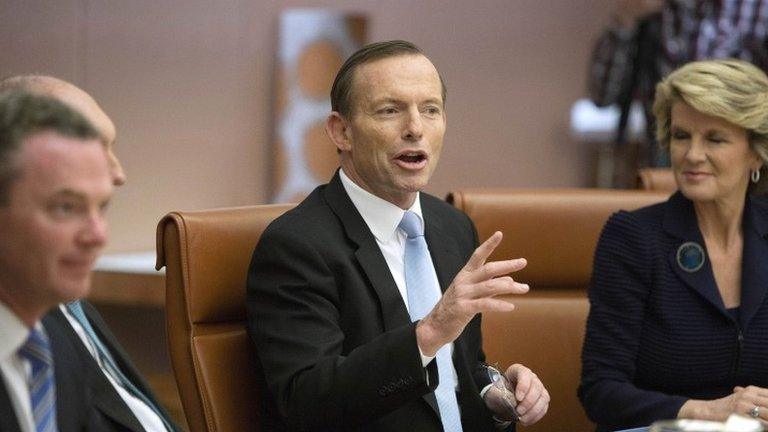 Australia"s new Prime Minister Tony Abbott, center, leads the first meeting of his full ministry in the Cabinet Room of Parliament House