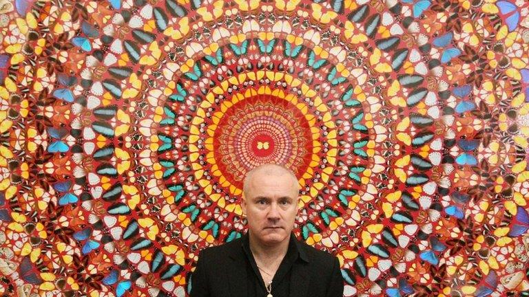 Artist Damien Hirst with his work "I Am Become Death, Shatterer of Worlds 2006", on display at Tate Modern art gallery in 2012