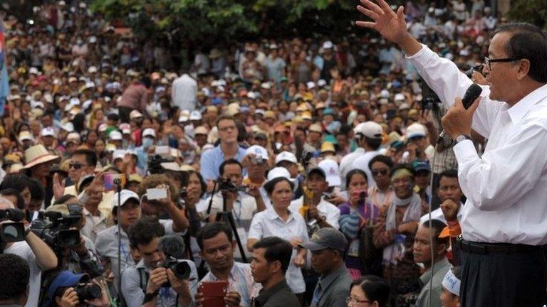 Leader of the opposition Cambodia National Rescue Party (CNRP) Sam Rainsy (R) speaks to supporters during a demonstration at the Democracy Park in Phnom Penh on 17 September 2013