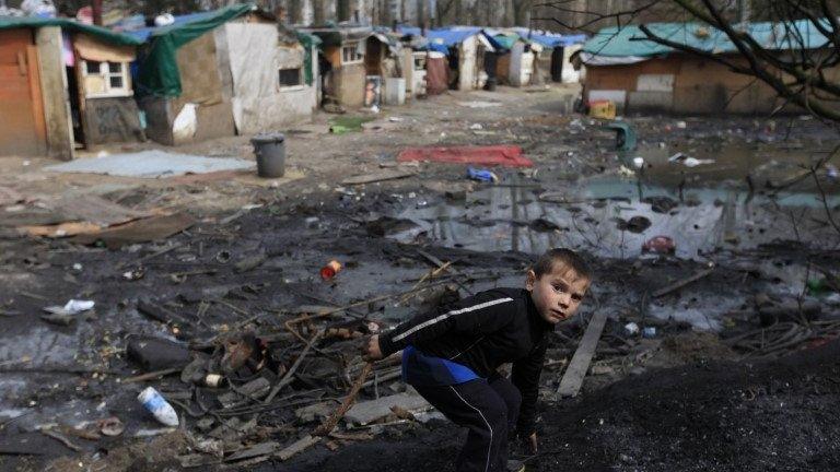 A Roma boy plays front of shelters in an illegal camp in Lille, northern France on International Roma Day on 8 April 2013