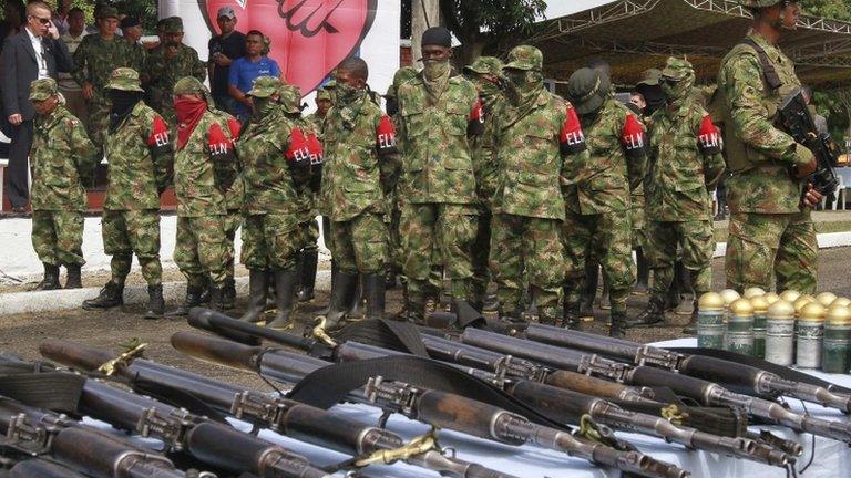 Defected members of Colombian guerrilla group ELN hand over their weapons at a military base in Cali 16 Jully, 2013