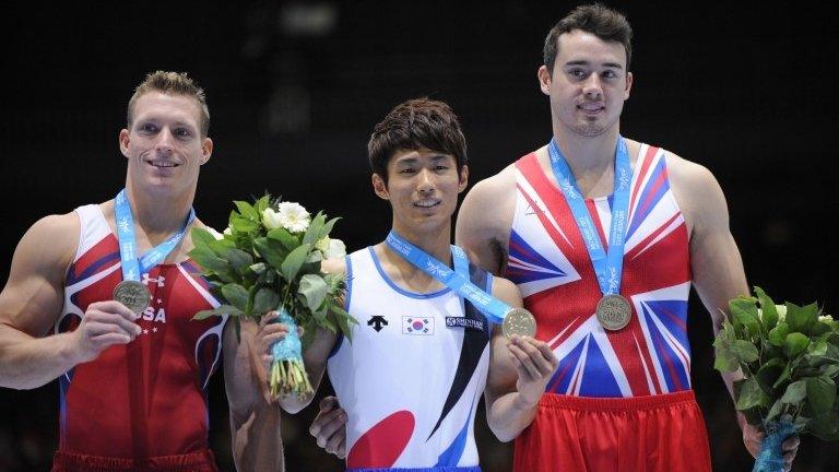 Kristian Thomas is presented with his bronze medal