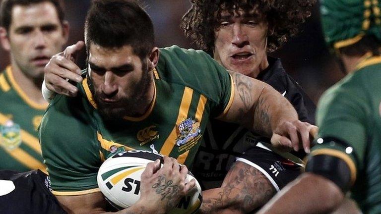 New Zealand's Kevin Proctor (second right) tackles Australia's James Tamou