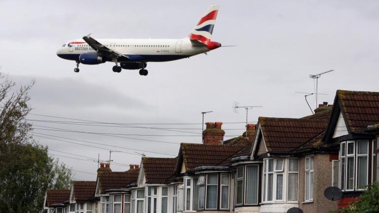 Plane flying over houses