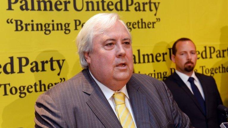 Australian mining billionaire and leader of the Palmer United Party (PUP) Clive Palmer (L) speaks as Australian Motoring Enthusiast Party (Amep) senator Ricky Muir (R) listens