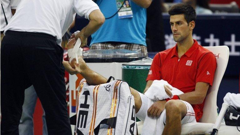 Novak Djokovic gets treatment for his injury in Shanghai