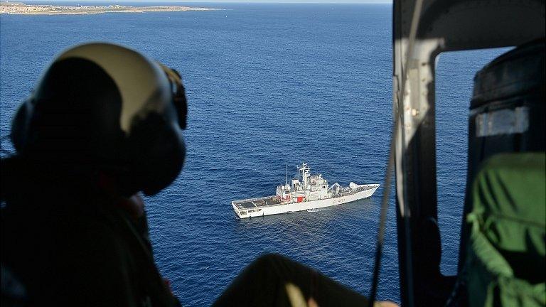 Italian Air Force helicopter looks down on navy ship. 9 Oct 2013