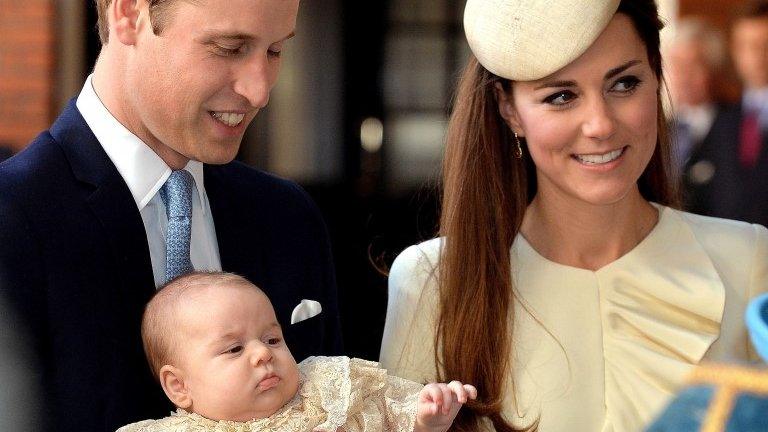 Prince George being carried by his father, the Duke of Cambridge