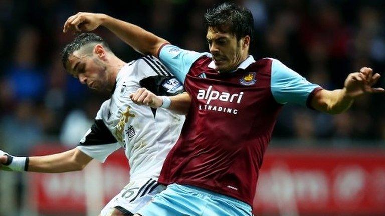 Alvaro Vazquez of Swansea in action against James Tomkins of West Ham