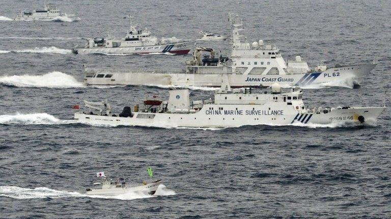 A Japanese fishing boat, bottom, a small Japanese pleasure boat, top centre, Japan Coast Guard vessels, third and fourth from bottom and top left, sail along with a Chinese surveillance ship near disputed islands called Senkaku in Japan and Diaoyu in China in the East China Sea, 23 April 2013