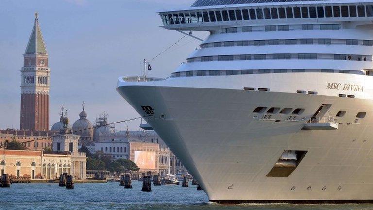 A giant cruise arrives in front of Saint Mark"s square in Venice