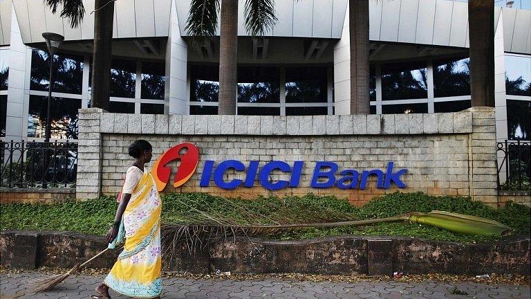 Lady walking past ICICI Bank headquarters in Mumbai