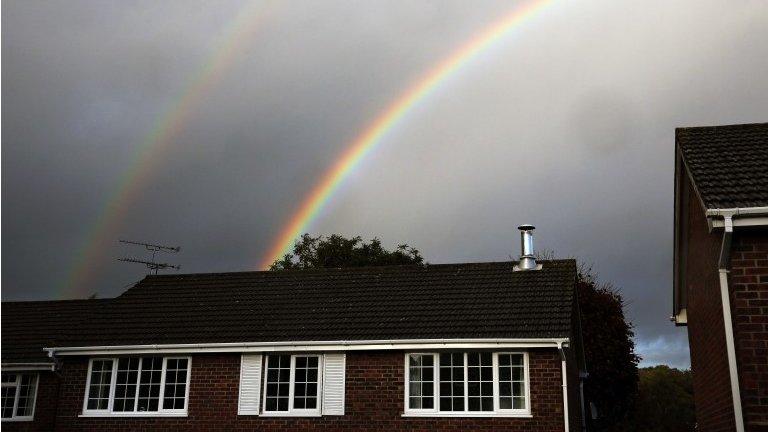 Houses and rainbow with clouds