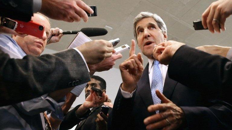 US Secretary of State John Kerry speaks with reporters at the U.S. Capitol before testifying to the Senate Banking and Urban Affairs Committee 13 November 2013