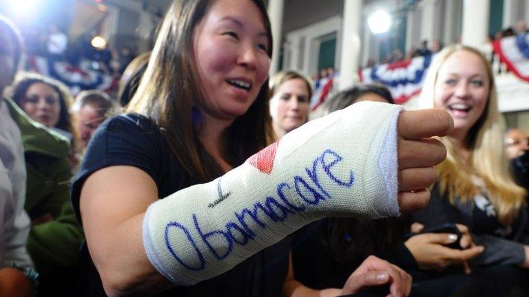 Cathey Park shows her arm in a cast on which "I love Obamacare" is written as she waits to hear US President Barack Obama speak on healthcare at the Faneuil Hall in Boston, Massachusetts, in this 30 October 2013