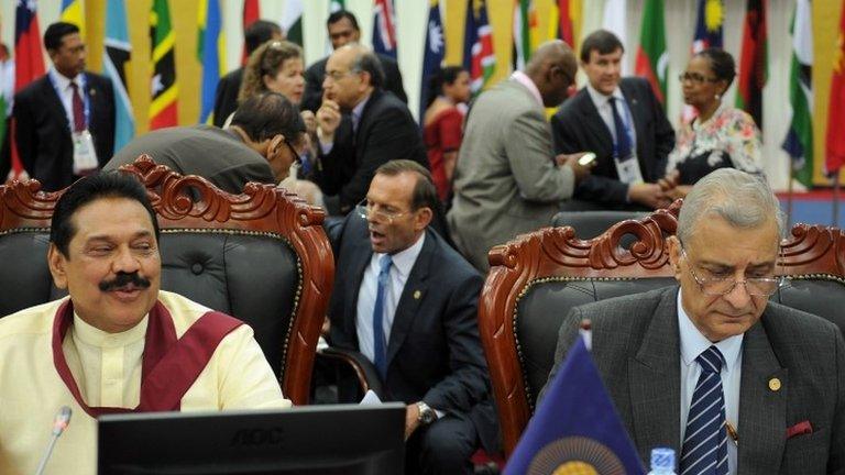 Sri Lankan President and Mahinda Rajapakse, Australian Prime Minister Tony Abbott (C) and Commonwealth Secretary General Kamalesh Sharma attend the final session of the Commonwealth Heads of Government Meeting in Colombo, 17 November 2013