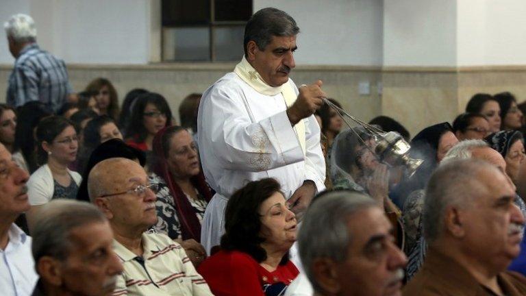 Iraqi Christians attend mass at the Mother of Continuous Aid Church in the Christian village of Ankawa, near the northern Kurdish city of Irbil, on 22 October 2013