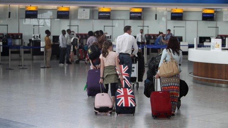 Passengers at check-in at Terminal 5 of Heathrow Airport