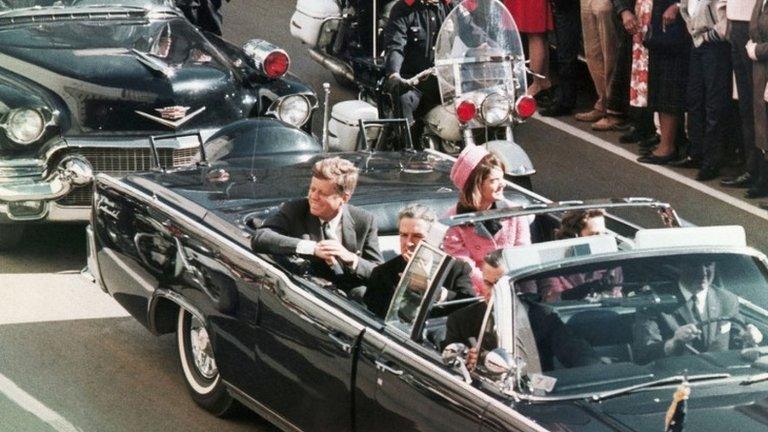 John F Kennedy's motorcade travels through Dallas