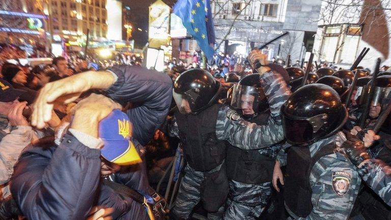 Protesters clash with riot police during a rally to support European Union (EU) integration in central Kiev