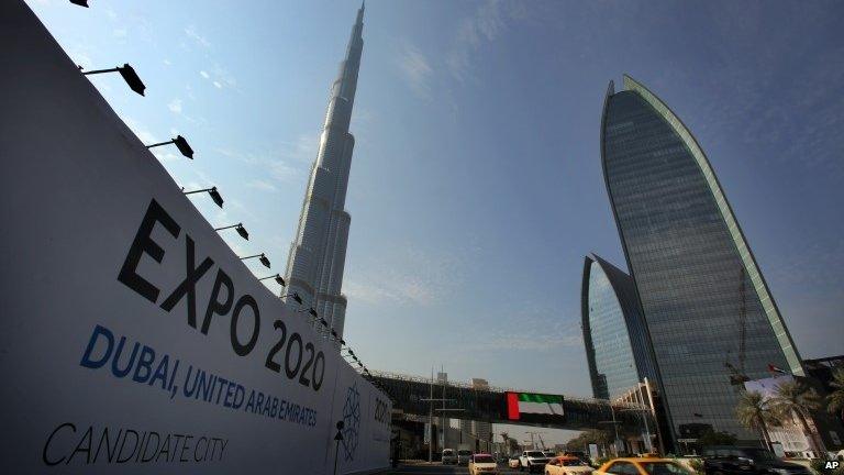 Vehicles pass by a billboard advertising Dubai as a candidate city for the Expo 2020 in Dubai, United Arab Emirates