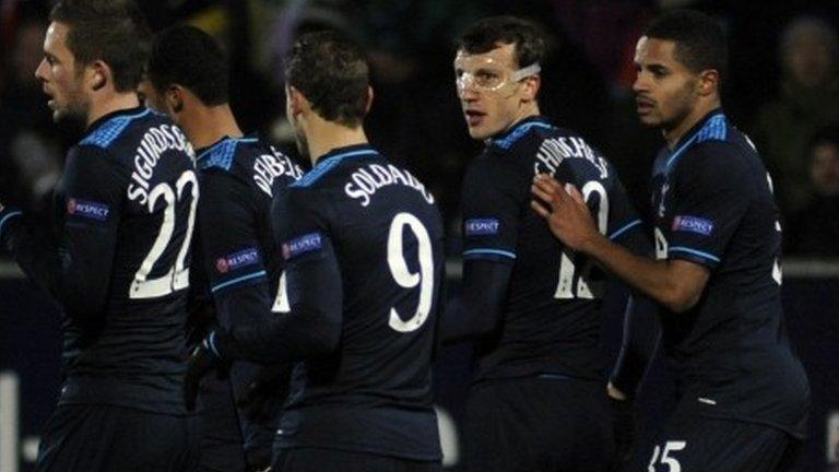 Tottenham's Vlad Chiriches (with mask) celebrates with team-mates after helping in the first goal v Tromso