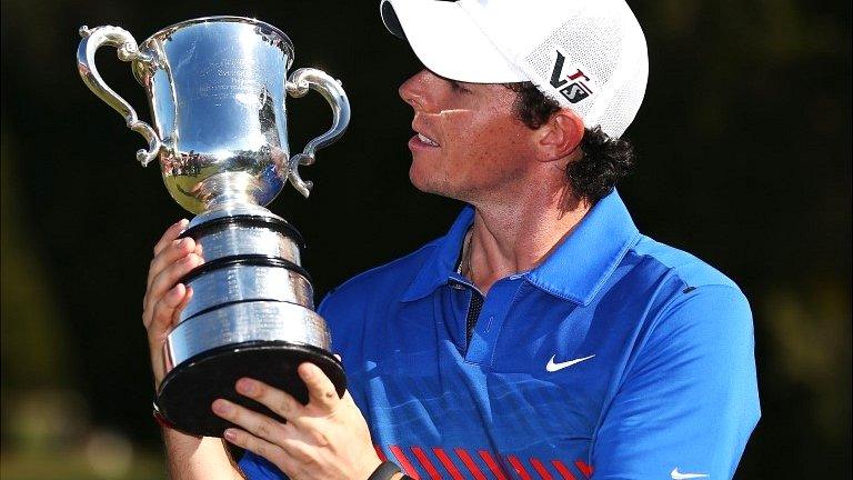 Rory McIlroy celebrates with the Australian Open trophy