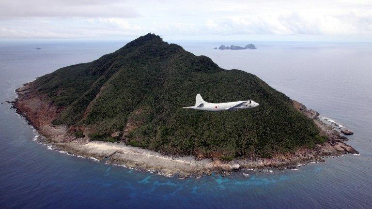 Japanese P-3C patrol plane flies over the disputed islets known as the Senkaku islands in Japan and Diaoyu islands in China, in the East China Sea on 13 October 2011