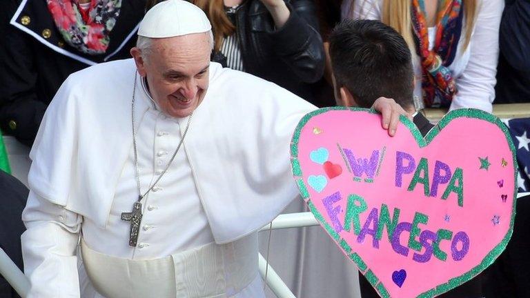 Pope Francis acknowledges the crowd from an open-air jeep ahead of his weekly audience in St Peter's Square on 27 March.