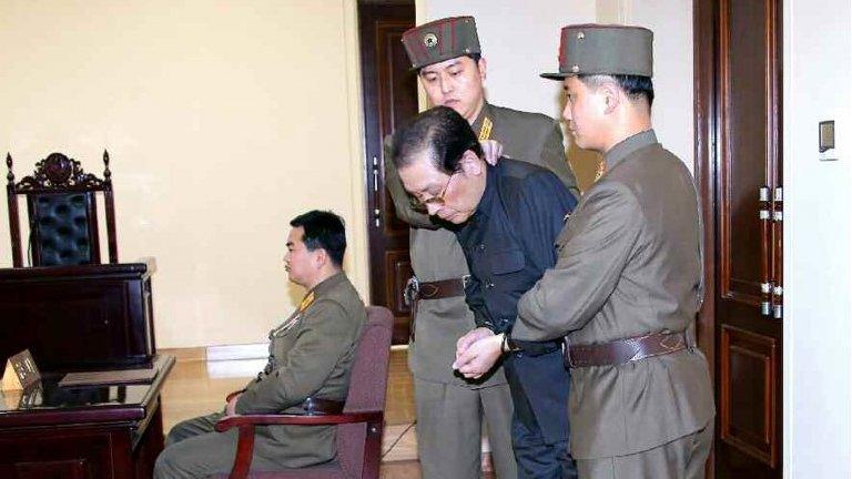 Chang Song-thaek (second right) being escorted in court on 12 December 2013