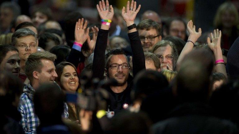 Volunteer SPD vote-counters cheer after results referendum on whether to enter into a grand coalition with its political rivals are announced