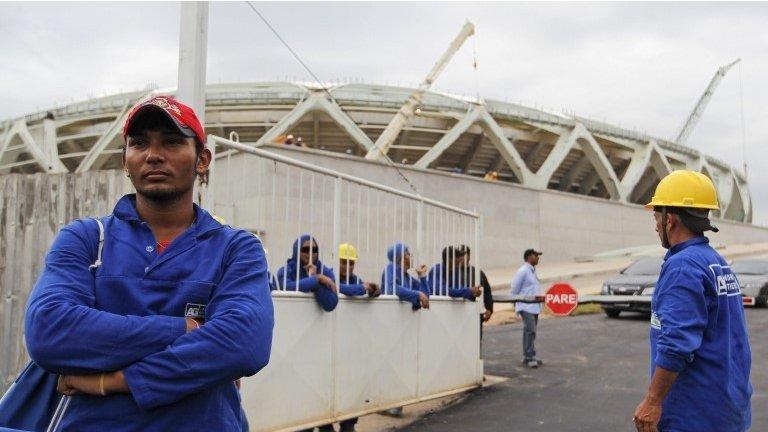 Workers gather outside the Arena Amazonia building site, in Manaus, Brazil