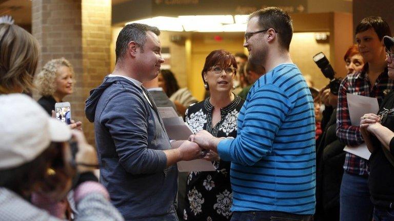 Isaac Troyo (L) and his partner Jed Mecham get married at the Salt Lake County Government Building in Salt Lake City, Utah 23 December 2013