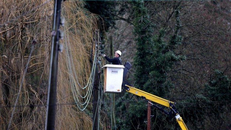 Man fixing power lines near Reigate, Surrey