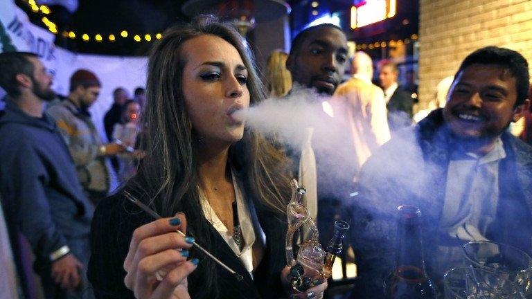 Partygoers smoke marijuana during a Prohibition-era themed New Year's Eve party celebrating the start of retail pot sales, at a bar in Denver 31 December 2013