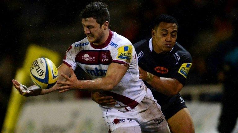 Sinoti Sinoti (r) of Newcastle Falcons tackles Tom Brady of Sale Sharks