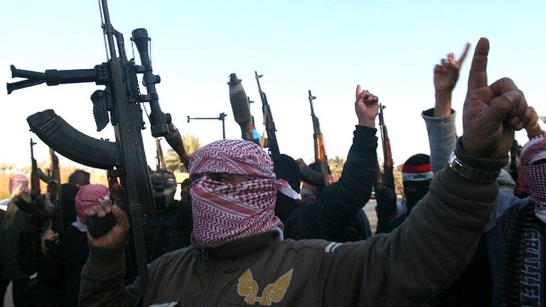 Gunmen gather in a street in Falluja as they chant slogans against Iraq's Shiite-led government