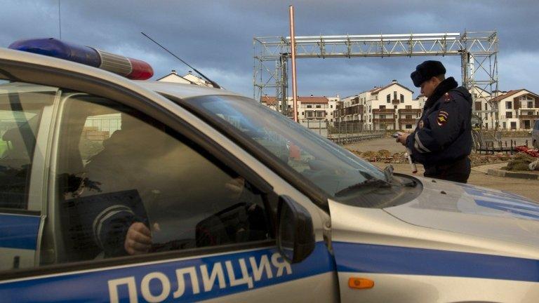 Russian police patrol near accommodation sites and venues in the Olympic Park near Sochi