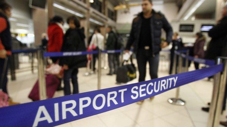 Romanians pass through airport security for a flight to Heathrow airport in Britain, at Otopeni international airport near Bucharest on 1 January