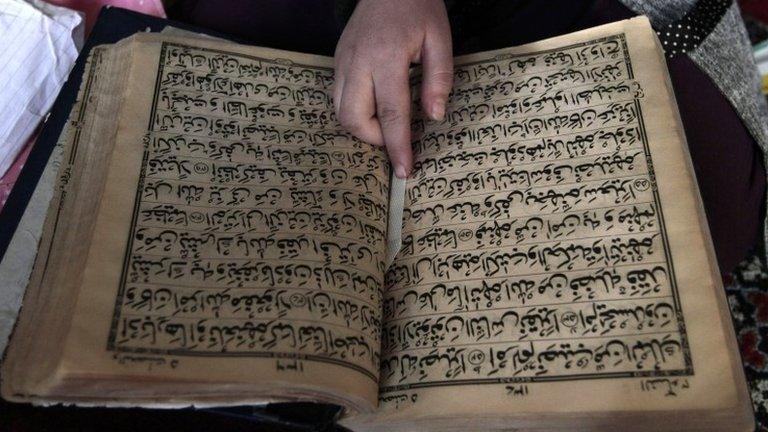 An Afghan girl learning to read the Koran