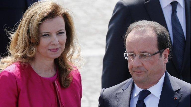 French President Francois Hollande and his companion Valerie Trierweiler attend the traditional Bastille day military parade on the Champs Elysee in Paris in this July 14, 2013 file photo.